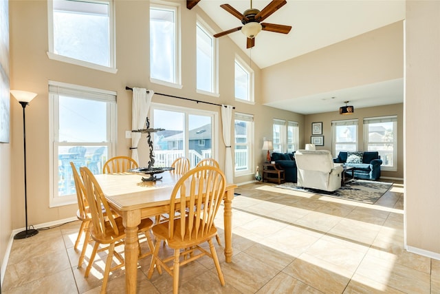 4406 Tampico Way, Galveston, TX 77554 - dining space with a ceiling fan, light tile patterned floors, high vaulted ceiling, and baseboards