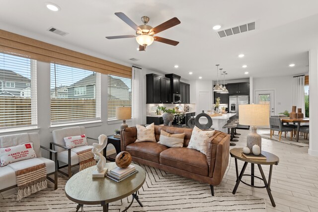15847 Invergelder Dr, Atascocita, TX 77346 - living area with plenty of natural light, visible vents, and a ceiling fan