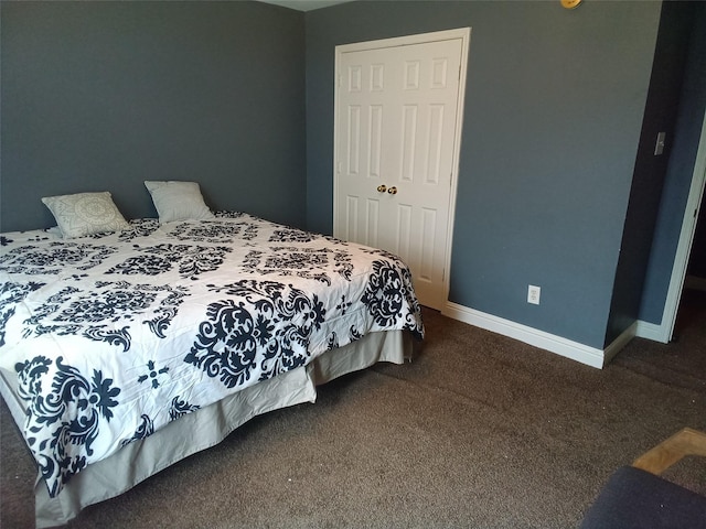 bedroom with baseboards and dark colored carpet