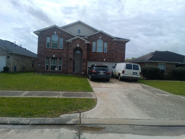 traditional-style home with driveway, a front yard, a garage, and brick siding