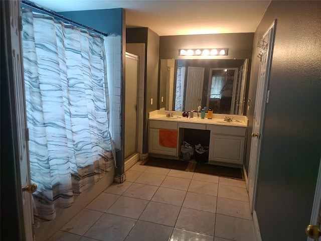 full bathroom with double vanity, a sink, and tile patterned flooring