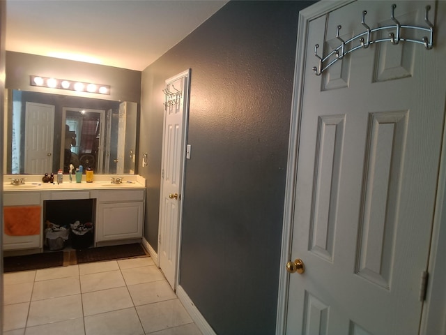 bathroom with double vanity, a sink, a stall shower, and tile patterned flooring