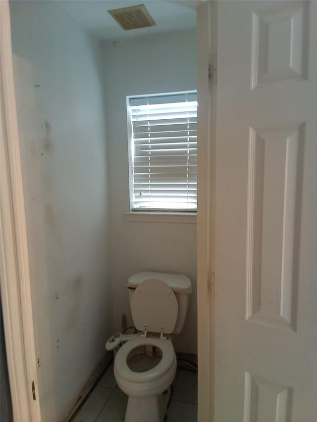 bathroom with visible vents, toilet, and tile patterned flooring
