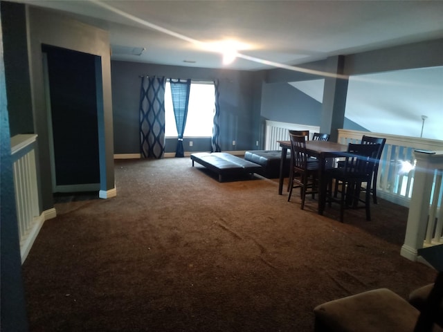 carpeted dining room with baseboards