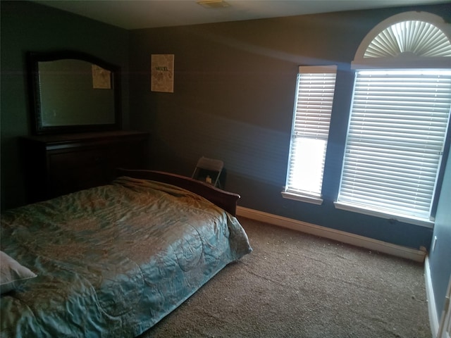 bedroom featuring carpet and baseboards