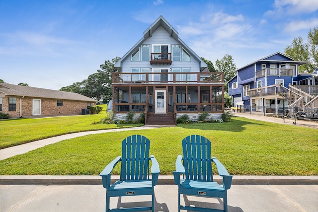 exterior space with a porch, a balcony, and a front yard