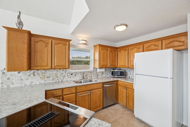 kitchen with a sink, tasteful backsplash, brown cabinetry, and stainless steel appliances