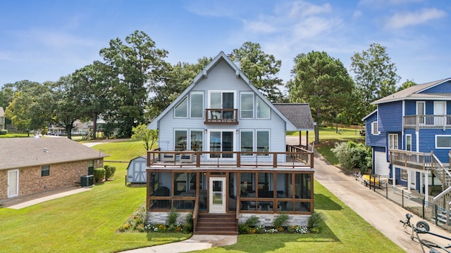 rear view of property featuring an outbuilding, a yard, a storage shed, and cooling unit