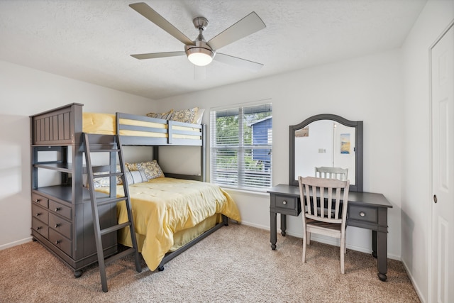 bedroom featuring carpet floors, a textured ceiling, and baseboards