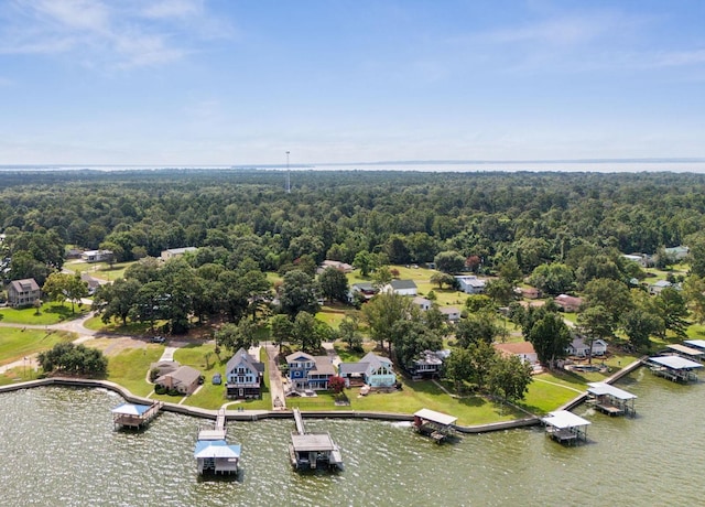 drone / aerial view with a water view, a residential view, and a wooded view
