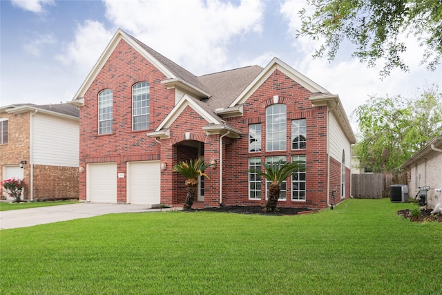 traditional-style house with driveway, a front yard, cooling unit, brick siding, and a garage