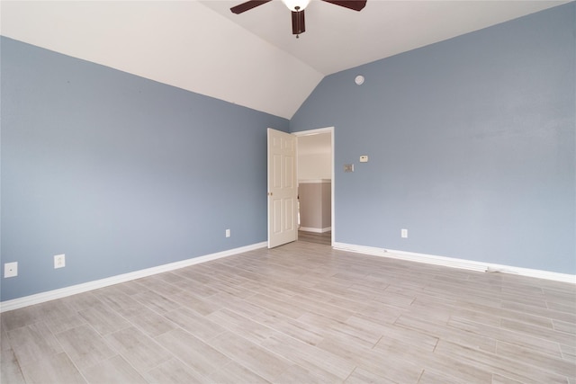spare room featuring baseboards, vaulted ceiling, a ceiling fan, and wood finish floors