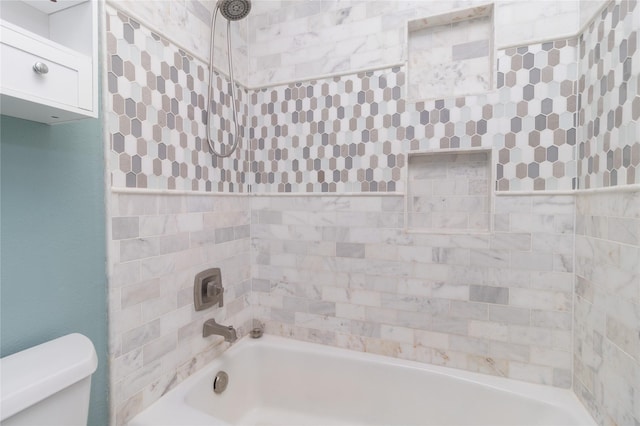 bathroom with tub / shower combination and toilet