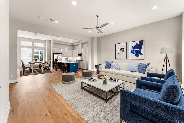 1033 Roberts St, Houston, TX 77003 - living area featuring a ceiling fan, light wood-type flooring, baseboards, and recessed lighting