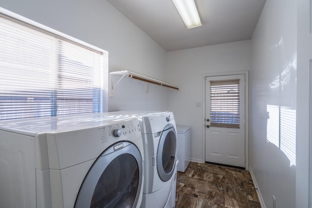 laundry room featuring baseboards, independent washer and dryer, and laundry area