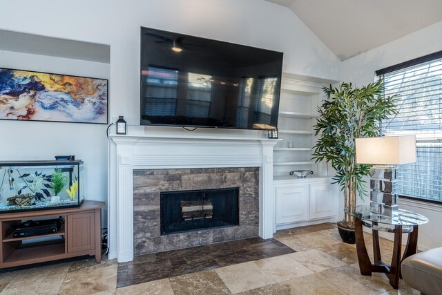 living room featuring vaulted ceiling and a fireplace