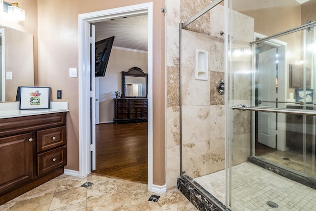 full bath with vanity, ornamental molding, and a stall shower
