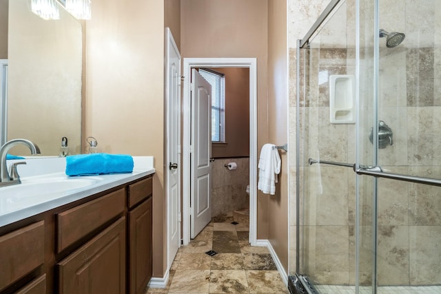 full bathroom featuring tile walls, toilet, a stall shower, and vanity