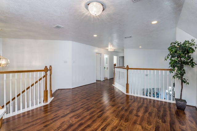 unfurnished room featuring visible vents, wood finished floors, recessed lighting, and a textured ceiling