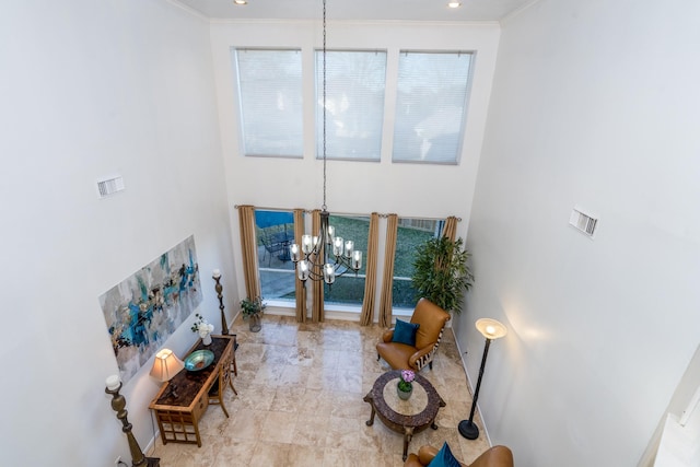 foyer entrance featuring baseboards, a notable chandelier, and ornamental molding