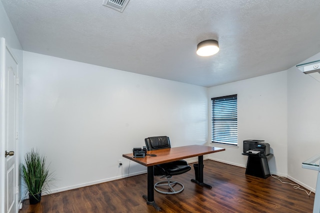office with wood finished floors, a textured ceiling, baseboards, and visible vents