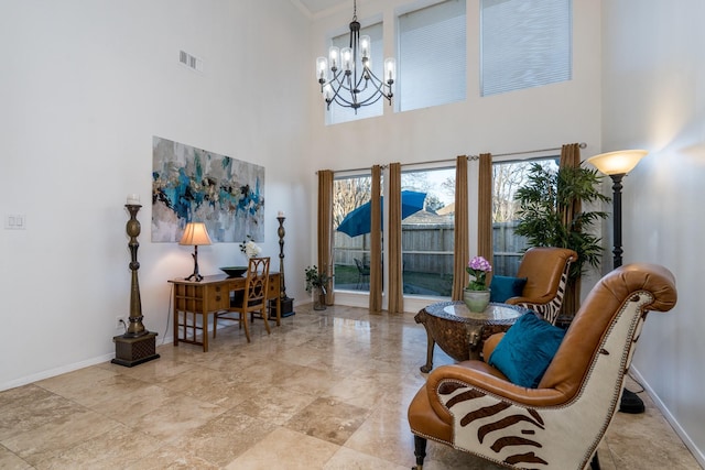 living area with baseboards, a notable chandelier, and visible vents