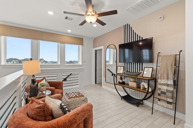 living area with baseboards, visible vents, ceiling fan, and recessed lighting