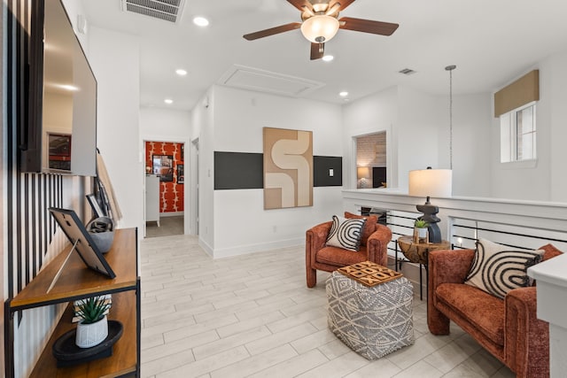 living area with attic access, recessed lighting, visible vents, and ceiling fan