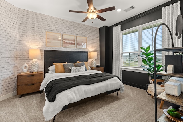 bedroom featuring visible vents, baseboards, carpet, and brick wall