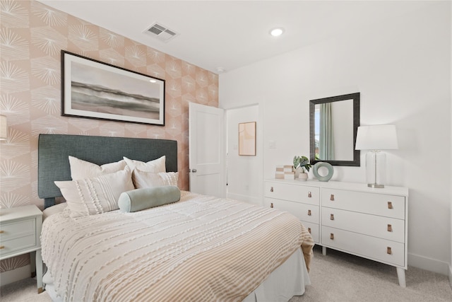 bedroom featuring visible vents, wallpapered walls, light carpet, and baseboards
