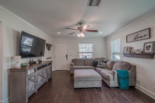 living room featuring crown molding, dark wood finished floors, baseboards, visible vents, and ceiling fan