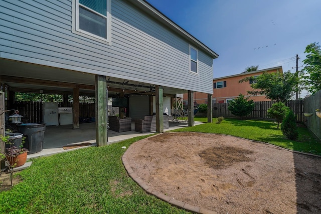 view of yard with a fenced backyard, an outdoor living space, and a patio
