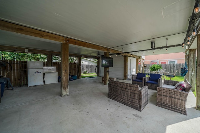 view of patio featuring fence and an outdoor living space