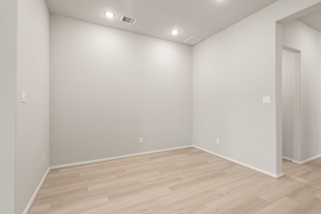 unfurnished room with baseboards, recessed lighting, visible vents, and light wood-style floors