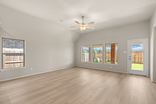 spare room featuring visible vents, light wood finished floors, baseboards, ceiling fan, and lofted ceiling
