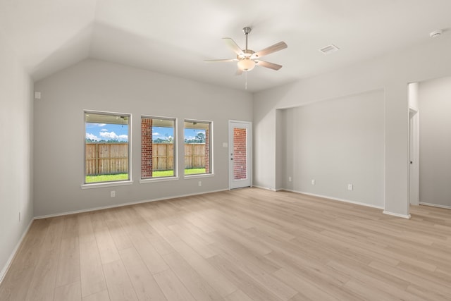 unfurnished room featuring lofted ceiling, baseboards, light wood finished floors, visible vents, and ceiling fan