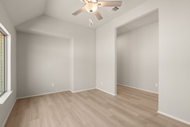 spare room featuring baseboards, light wood-type flooring, visible vents, and a ceiling fan