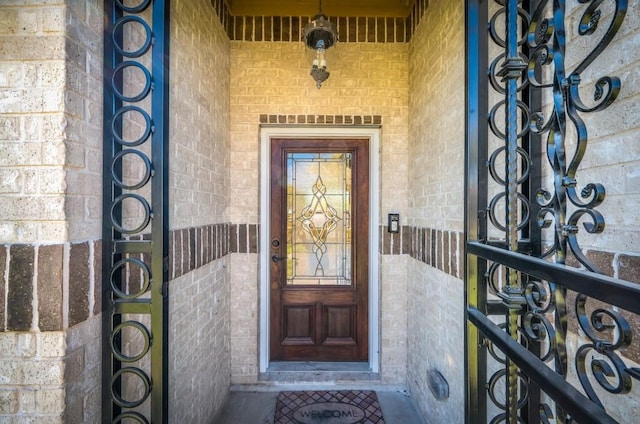entrance to property featuring brick siding