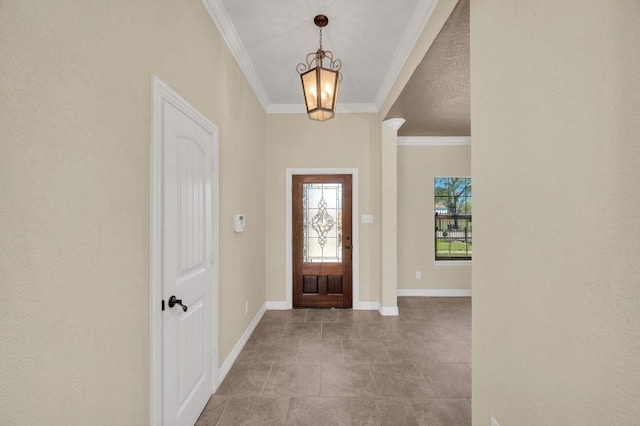 foyer featuring ornamental molding, baseboards, and a chandelier