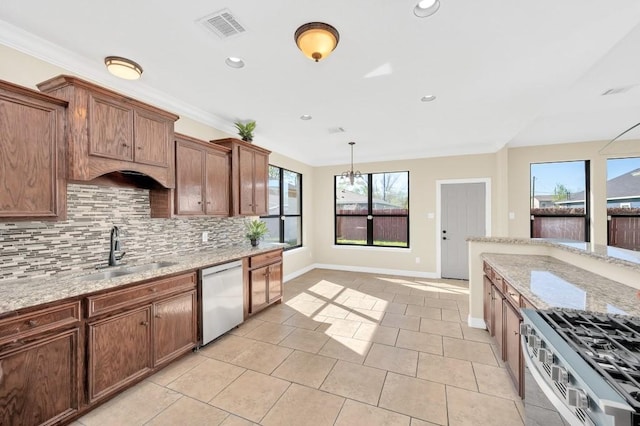 kitchen featuring visible vents, dishwasher, tasteful backsplash, a sink, and stainless steel gas stove