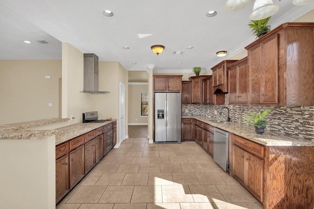 kitchen with a sink, light stone countertops, appliances with stainless steel finishes, wall chimney range hood, and decorative backsplash