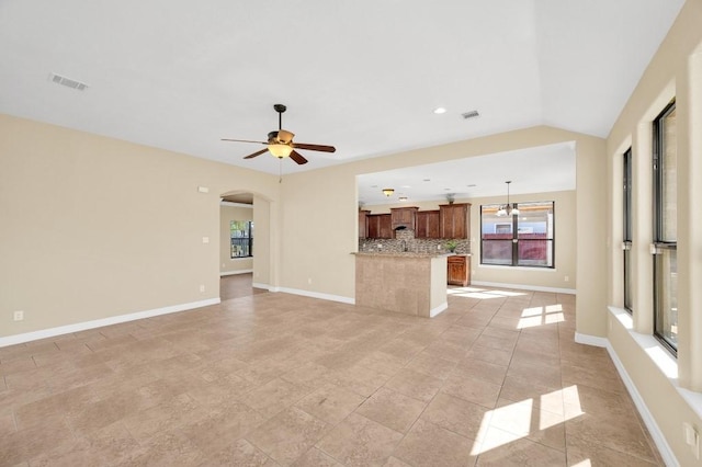 unfurnished living room with baseboards, ceiling fan, and visible vents