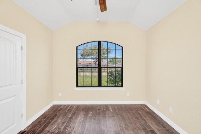 spare room featuring baseboards, vaulted ceiling, wood finished floors, and ceiling fan