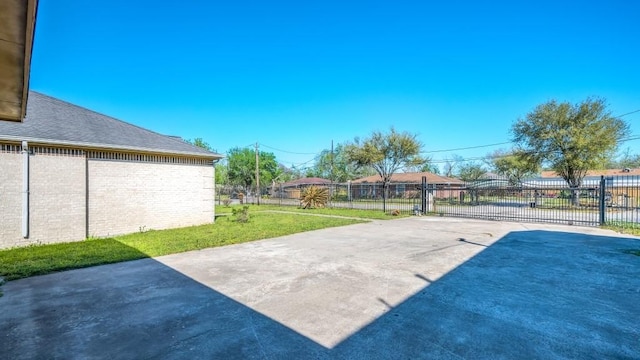 view of patio / terrace with driveway and fence