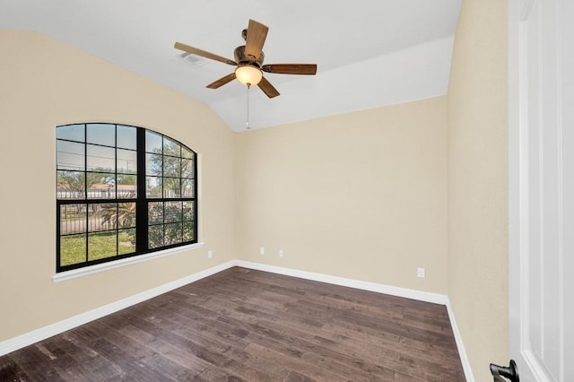 spare room featuring dark wood-style flooring, baseboards, lofted ceiling, and ceiling fan