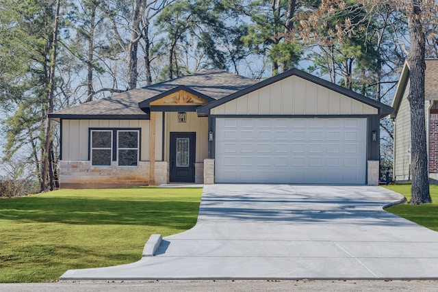 view of front of house featuring a garage, concrete driveway, a front lawn, board and batten siding, and roof with shingles