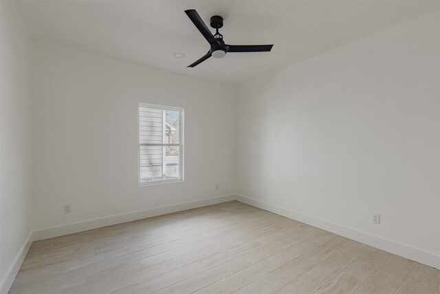 empty room with baseboards, light wood finished floors, and ceiling fan