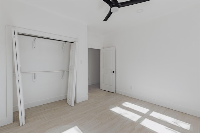 unfurnished bedroom featuring baseboards, a closet, ceiling fan, and wood finished floors