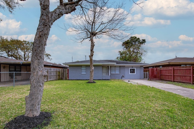 2821 1st Ave N, Texas City, TX 77590 - back of house with a lawn, fence, and brick siding