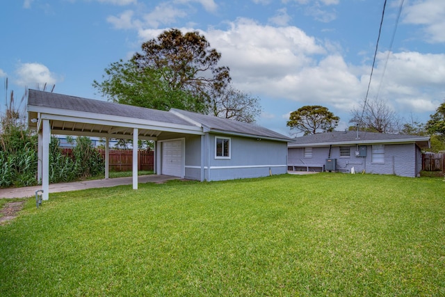 2821 1st Ave N, Texas City, TX 77590 - rear view of house with a garage, fence, and a yard
